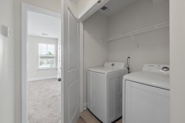 7780 Montview Rd, North Charleston, SC 29418 - clothes washing area with washing machine and dryer, baseboards, and light colored carpet