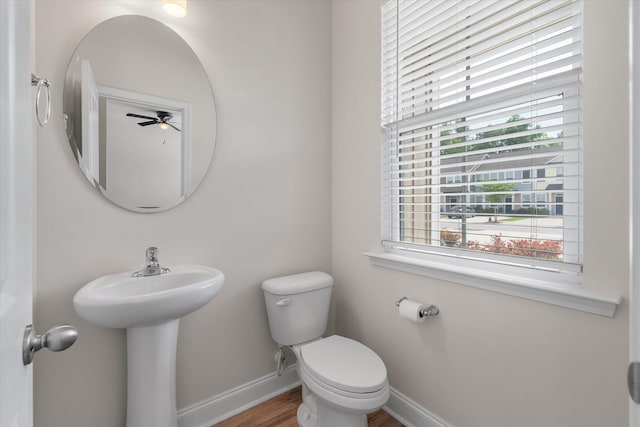 7780 Montview Rd, North Charleston, SC 29418 - half bathroom featuring baseboards, ceiling fan, toilet, wood finished floors, and a sink