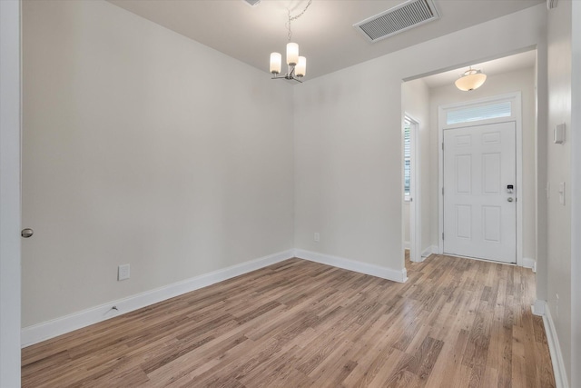 7780 Montview Rd, North Charleston, SC 29418 - entryway with light wood-type flooring, baseboards, and a chandelier