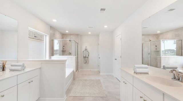 bathroom featuring vanity, a garden tub, recessed lighting, and a stall shower