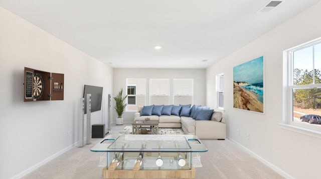 carpeted living room with visible vents and baseboards