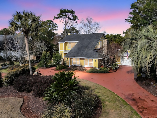 view of front of house featuring concrete driveway and stucco siding