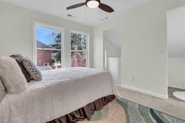 bedroom with carpet floors, a ceiling fan, visible vents, and baseboards