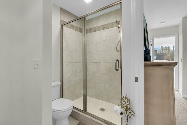 bathroom featuring a shower stall and toilet