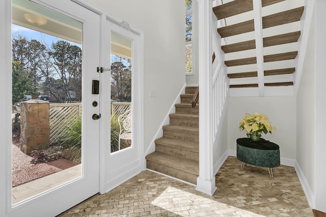 doorway featuring brick floor, french doors, stairway, and baseboards