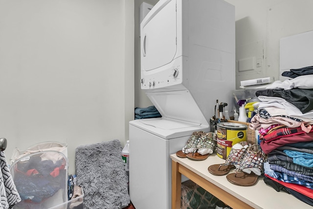 clothes washing area with stacked washer and clothes dryer