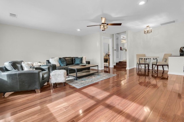 living area featuring recessed lighting, visible vents, baseboards, and wood finished floors