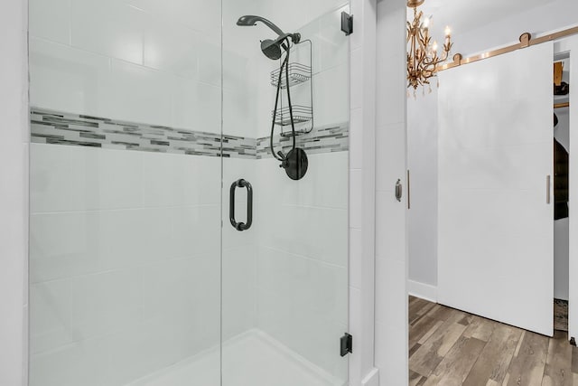 full bath featuring a stall shower and wood finished floors