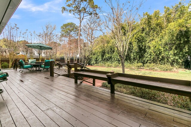 wooden deck featuring outdoor dining space and fence