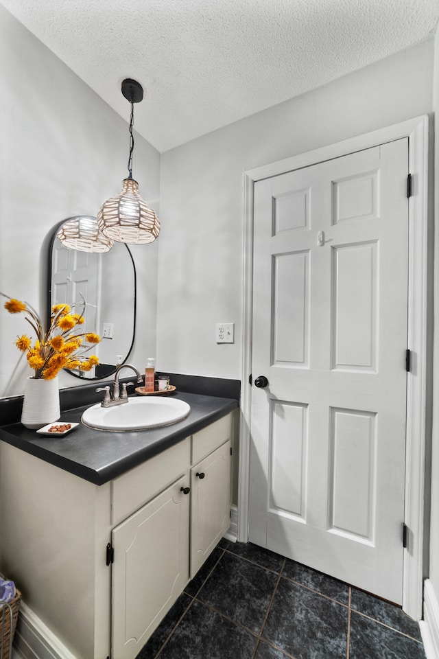 bathroom featuring vanity, a textured ceiling, and tile patterned floors