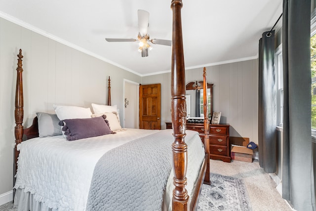 bedroom with wood walls, light colored carpet, ceiling fan, and crown molding