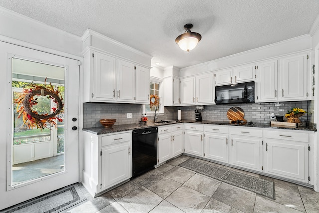 kitchen featuring white cabinets, black appliances, sink, backsplash, and dark stone countertops