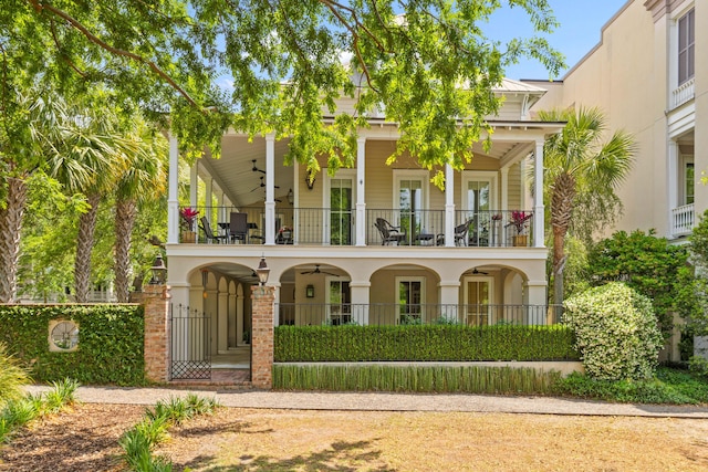 rear view of house with a balcony and a ceiling fan