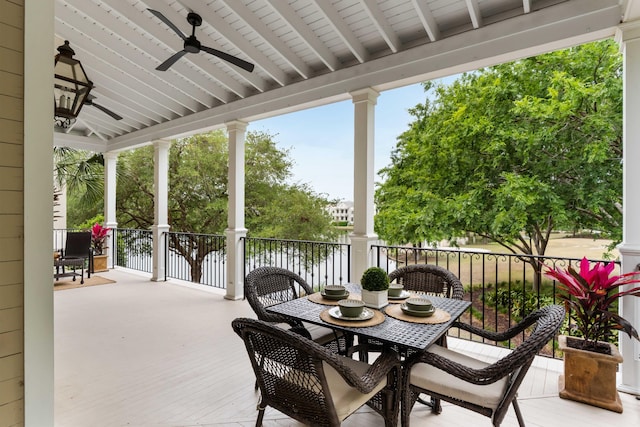 view of patio featuring a water view, ceiling fan, and outdoor dining space
