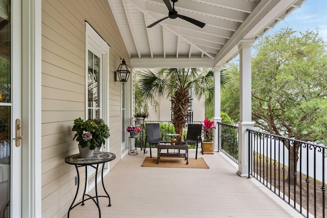 wooden terrace with a ceiling fan and covered porch