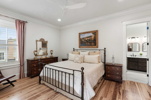 bedroom featuring light wood finished floors, crown molding, connected bathroom, recessed lighting, and baseboards