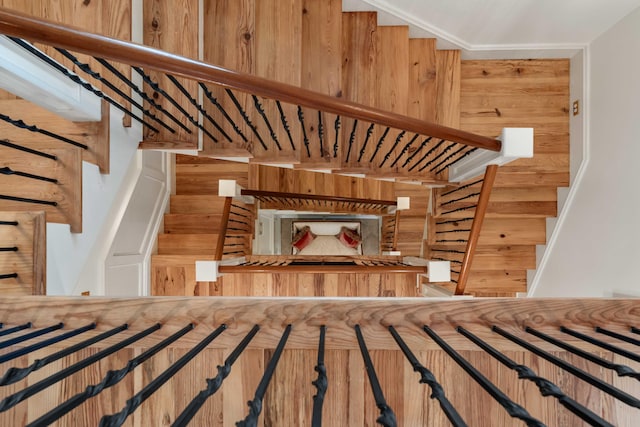 stairs featuring wood walls