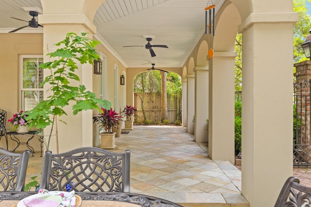 view of patio with a ceiling fan and fence