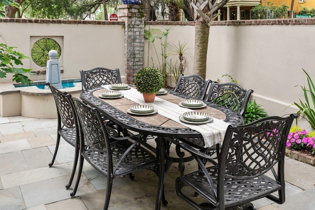view of patio / terrace with outdoor dining space and fence