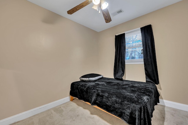 bedroom with ceiling fan and light carpet