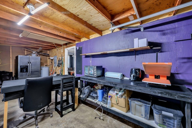 basement featuring stainless steel refrigerator with ice dispenser