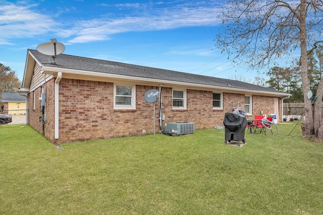 back of house featuring a lawn and cooling unit