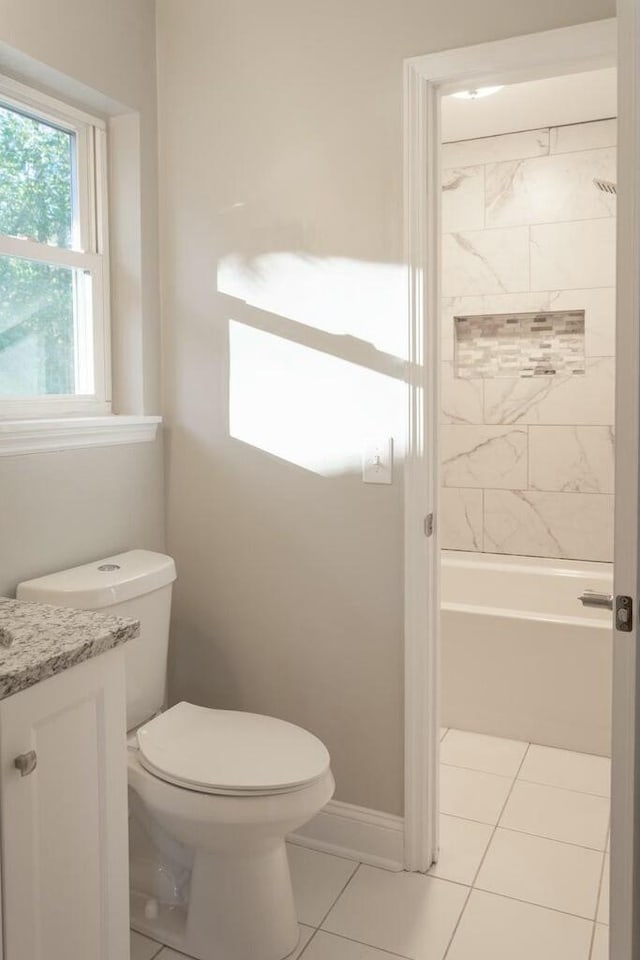 bathroom featuring vanity, baseboards, tile patterned flooring, shower / bath combination, and toilet