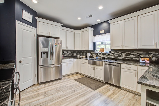 2021 Asher Loop, Summerville, SC 29485 - kitchen featuring appliances with stainless steel finishes, a sink, recessed lighting, decorative backsplash, and light wood-style flooring