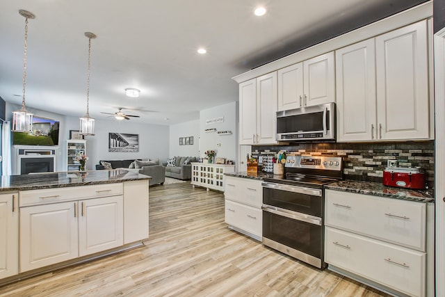 2021 Asher Loop, Summerville, SC 29485 - kitchen with stainless steel appliances, a ceiling fan, open floor plan, tasteful backsplash, and a fireplace