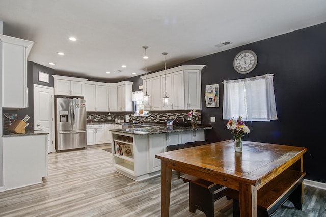 2021 Asher Loop, Summerville, SC 29485 - kitchen with stainless steel fridge with ice dispenser, decorative backsplash, white cabinets, light wood finished floors, and open shelves