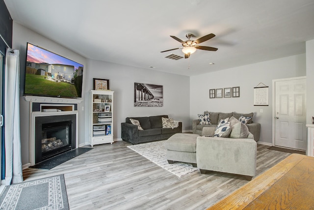 2021 Asher Loop, Summerville, SC 29485 - living area featuring light wood-type flooring, ceiling fan, a fireplace, and baseboards