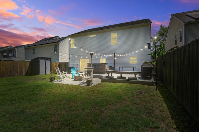 2021 Asher Loop, Summerville, SC 29485 - back of property at dusk featuring a patio area and an outdoor fire pit