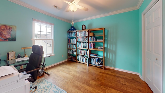 office space featuring baseboards, visible vents, ceiling fan, ornamental molding, and wood finished floors