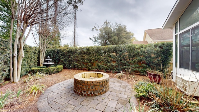 view of patio with a fire pit and fence