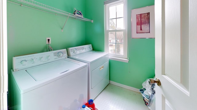 washroom with laundry area, baseboards, separate washer and dryer, and a wealth of natural light