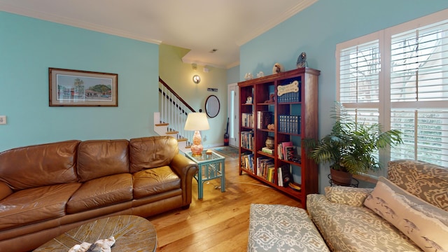 living area with stairs, ornamental molding, and wood finished floors