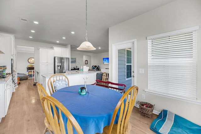 dining area featuring light wood finished floors, visible vents, and recessed lighting
