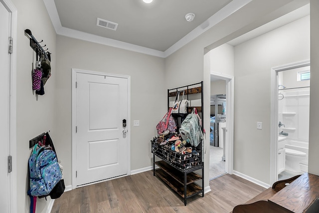 mudroom featuring baseboards, wood finished floors, and visible vents