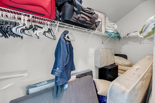 walk in closet with lofted ceiling