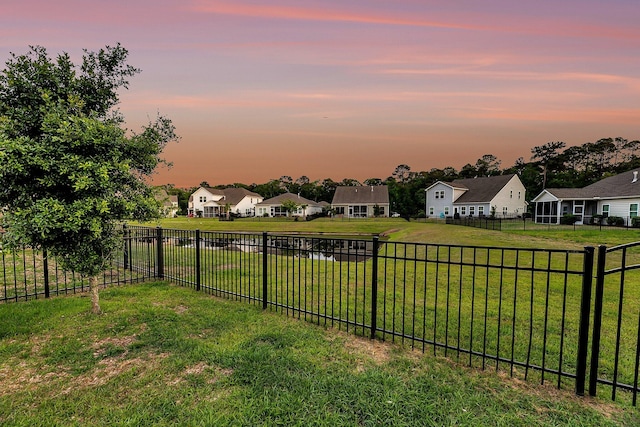 view of yard featuring fence and a residential view