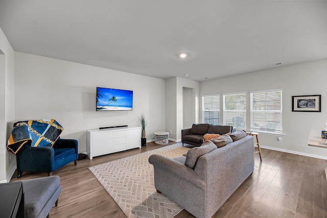 living area with visible vents, wood finished floors, baseboards, and recessed lighting