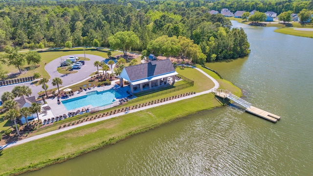 birds eye view of property with a view of trees and a water view