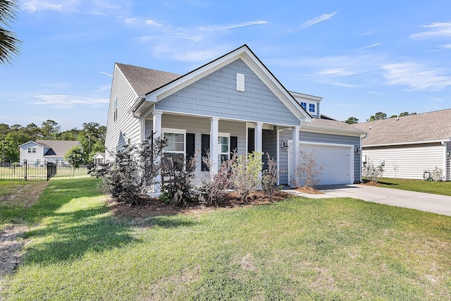 view of front of home featuring driveway, a porch, fence, a garage, and a front yard
