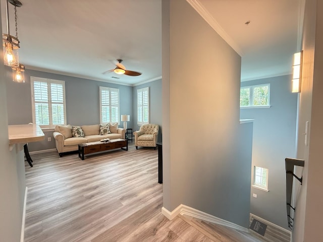 1225 Blakeway St Unit 906, Charleston, SC 29492 - living area with crown molding, baseboards, light wood-style floors, and a ceiling fan