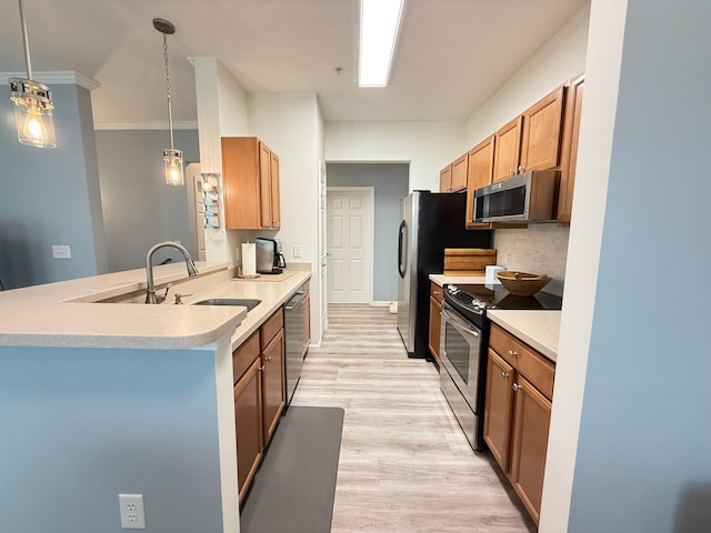 1225 Blakeway St Unit 906, Charleston, SC 29492 - kitchen with appliances with stainless steel finishes, a peninsula, light wood finished floors, light countertops, and crown molding