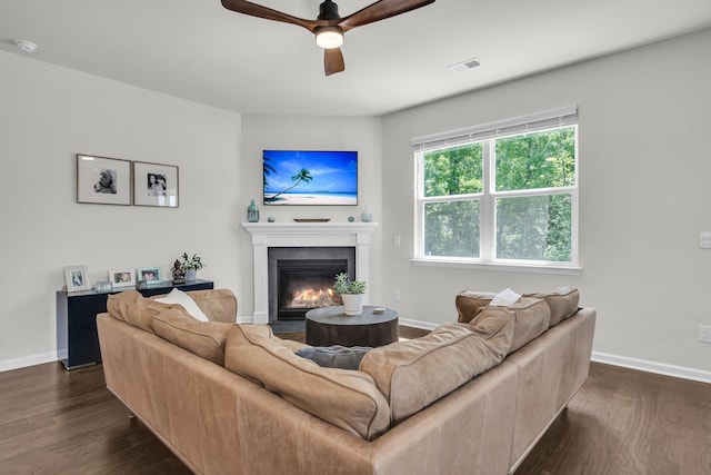 1132 Wading Point Blvd, Huger, SC 29450 - living room with ceiling fan, dark wood-style flooring, a fireplace with flush hearth, and baseboards