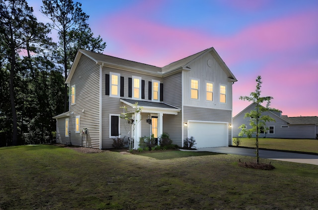1132 Wading Point Blvd, Huger, SC 29450 - view of front of home featuring a garage, driveway, a porch, and a front lawn