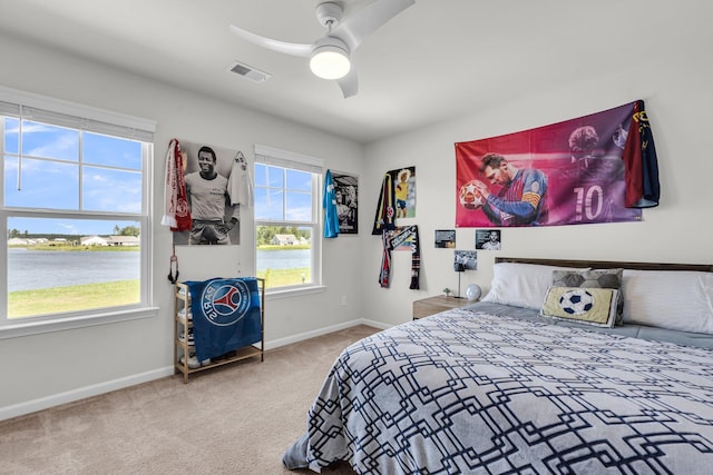 1132 Wading Point Blvd, Huger, SC 29450 - carpeted bedroom featuring a water view, baseboards, and a ceiling fan