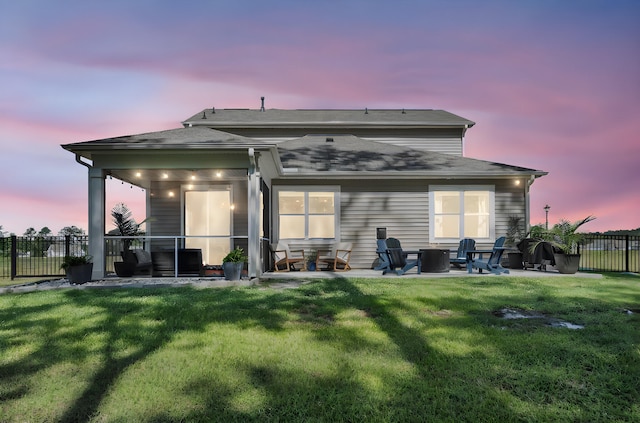 1132 Wading Point Blvd, Huger, SC 29450 - back of property at dusk with a patio, a fire pit, and roof with shingles