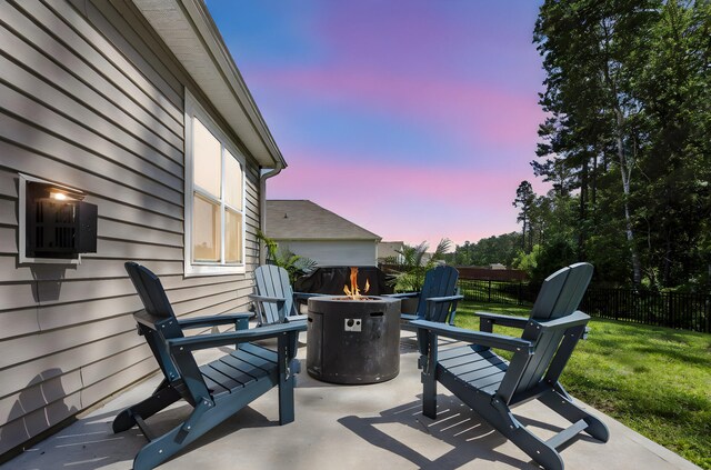 1132 Wading Point Blvd, Huger, SC 29450 - patio terrace at dusk featuring an outdoor fire pit